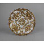 A Meissen porcelain shallow dish with moulded gilt floral and foliate decoration on white ground,