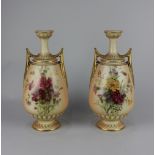 A pair of Royal Worcester blush ivory porcelain two-handled vases, with floral decoration and gilt