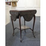 A dark stained and carved side table the square top with four shaped drop leaves, with under