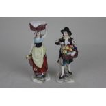 A pair of small porcelain figures of fruit pickers, both with gold Chelsea Derby type marks verso,