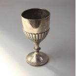 A George V small silver trophy cup demi-reeded with knopped stem, presentation inscription, 2.8oz