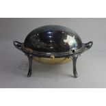 A silver plated two handled revolving dome top oval tureen with two liners on four scroll legs 34cm