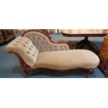 A Victorian button upholstered chaise longue with carved and pierced frame and serpentine seat on