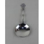 An Edward VII silver wine spoon circular bowl and cast handle with figure and trefoil terminal,