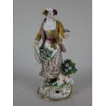 A 19th century porcelain figure of a flower seller a lamb at her feet on scroll base with gilt