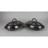 A pair of silver plated oval tureens and domed covers with detachable handles and beaded borders,