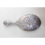 An Edward VII silver dressing table hand mirror oval glass with floral embossed decoration, engraved