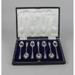 A cased set of six George V silver coffee spoons and matching sugar spoon maker W S Savage & Co,