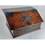 A 17th / 18th century oak bible box the hinged sloping lid carved with initials JE and date 1698