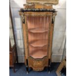 A Louis XV style kingwood vitrine with caddy top and serpentine glazed door enclosing three shaped