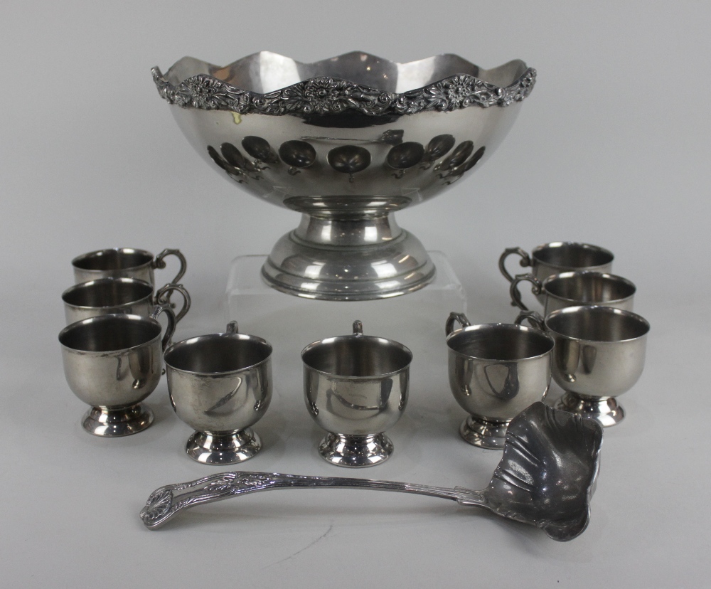 A silver plated punch bowl with cast scalloped border, nine hanging cups and ladle, 31cm (a/f)