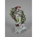 A Derby porcelain bocage figure of a piper with a dog at his feet, on scroll base with gilt