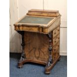 A Victorian Davenport desk having stationary compartment with hinged cover over writing slope and
