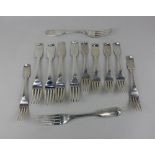 A set of six Victorian silver Fiddle pattern table forks and six dessert forks with engraved