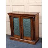 An early 19th century rosewood chiffonier with two grille fronted panel doors and pleated green