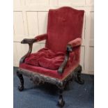 A George II style carved mahogany open armchair, the squared back with serpentine top rail flanked