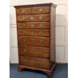 A mahogany stained tall chest of two short over six graduated long drawers, with pierced brass