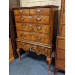 A Queen Anne walnut chest on stand with moulded edge top above two short and three long oak lined