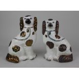 A pair of Staffordshire pottery spaniels 24cm high