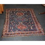 A Qashqai type long pile rug, red ground, with central repeat medallion motif surrounded by birds