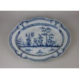 An early 19th century pearlware blue and white meat dish decorated with a Chinese landscape 41.5cm