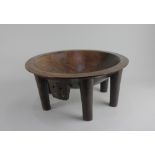 A Kava mixing bowl possibly Fijian, on six carved legs 40cm diameter