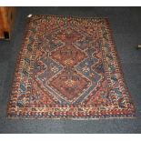 A Qashqai type rug, blue ground with red geometric motifs 146cm long by 103cm wide