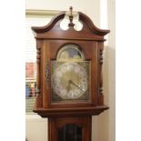 A reproduction mahogany longcase clock the brass sun and moon dial marked Emperor Clock Co Ltd, over