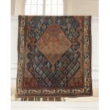 A Qashqai type rug, pale red ground, with central medallion amongst designs of people, plants and