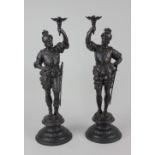 A pair of bronzed metal figures of two knights, possibly candlesticks 44cm high (a/f - both