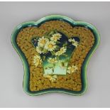 A large Doulton Lambeth charger by A Euphemia Thatcher, of shaped form, decorated with daisies on