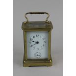 A brass carriage clock, the white enamel dial with Arabic numerals and subsidary dial, 11cm high,