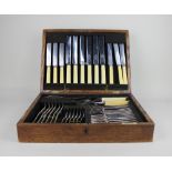 A forty-piece canteen of silver plated cutlery setting for six in fitted oak case by Alexander Clark