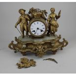 A 19th century French gilt metal and onyx figural mantle clock, with drum shape dial flanked by