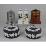 A pair of Wedgwood black Jasperware pots and covers decorated with fruiting vines, a ceramic salt