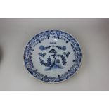 An 18th century Bristol Delft blue and white charger decorated with two fighting cockerels, insect