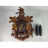 A carved wood black forest style cuckoo clock, the eight day movement marked Forester, 52cm high