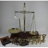 A W & T Avery set of counter-top brass beam scales on mahogany base 68cm high by 61cm wide including