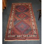 A Belouch type rug, brown ground with three geometric medallions within multiple borders 168cm