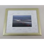 A framed signed photograph of Concorde with the Red Arrows 38.5cm by 48.5cm including signed mount