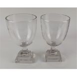 A near pair of Georgian glass sweetmeat dishes on faceted stem and square stepped base 23cm high (
