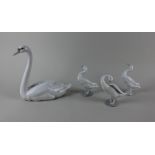 A Lladro porcelain model of a swan 21.5cm high, together with three Lladro porcelain models of white