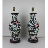 A pair of Chinese porcelain baluster vases adapted to table lamps, decorated with butterflies, flora