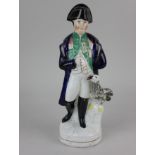 A Staffordshire pottery figure of Napoleon with bird 30cm high (a/f - repair)