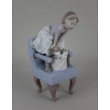 A Lladro porcelain 1998 event figurine of a young girl standing on a chair with kittens, 24cm