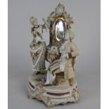 A Continental ceramic nodding figure group of a couple before a dressing table, 25.5cm high