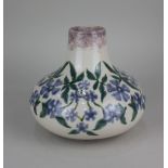 A Cobridge stoneware 'Perriwinkle' vase of squat form decorated with blue flowers on cream