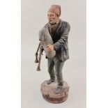 A painted pottery figure of a bagpiper 34cm high (a/f)
