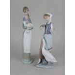A Lladro porcelain figure of a girl holding a lamb no. 4505 26.5cm high, together with another of