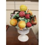 An Italian pottery model of a fruit filled urn, marked Italy to base, 28cm high